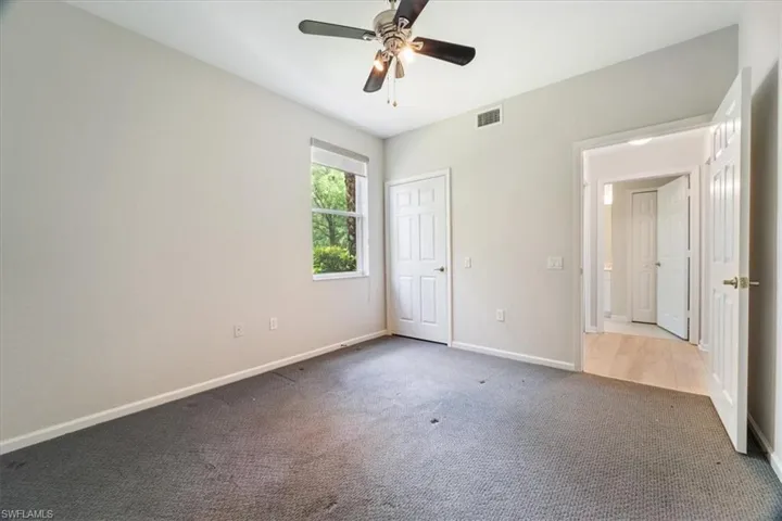 Unfurnished bedroom featuring carpet floors and a ceiling fan