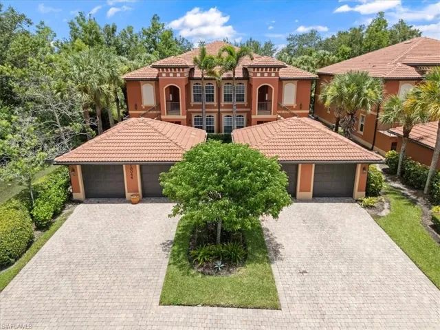 Mediterranean / spanish house featuring stucco siding, decorative driveway, a tiled roof, and a garage