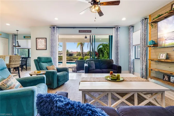 Living area featuring a ceiling fan, recessed lighting, and wood finished floors