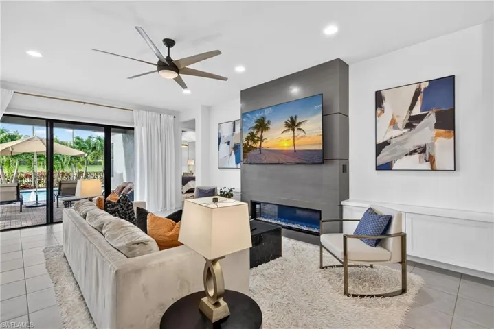 Recessed lighting, ceiling fan,  built-in electric fireplace, and tiled flooring
