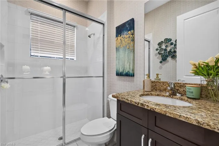 2nd bathroom (1st floor). Shower with clear glass enclosure and white tiled walls