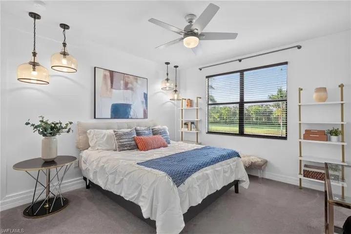 2nd bedroom. Custom built-in shelves, walk-in closet, and recessed lighting, ceiling fan with integrated light, and dual pendant lights provide ample illumination