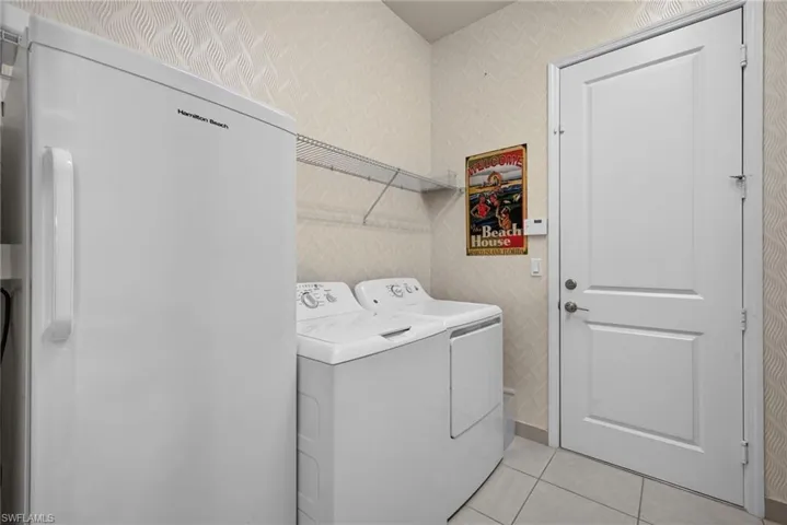 Large 1st floor laundry room, with storage, refrigerator, laundry chute from 2nd floor