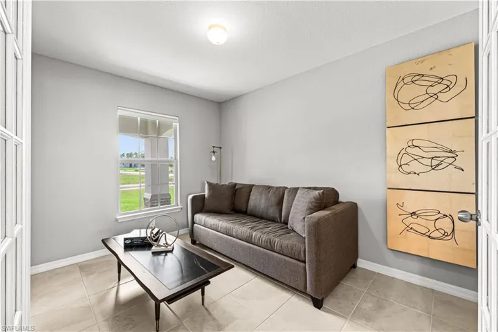 Living room with light tile patterned floors and a textured ceiling