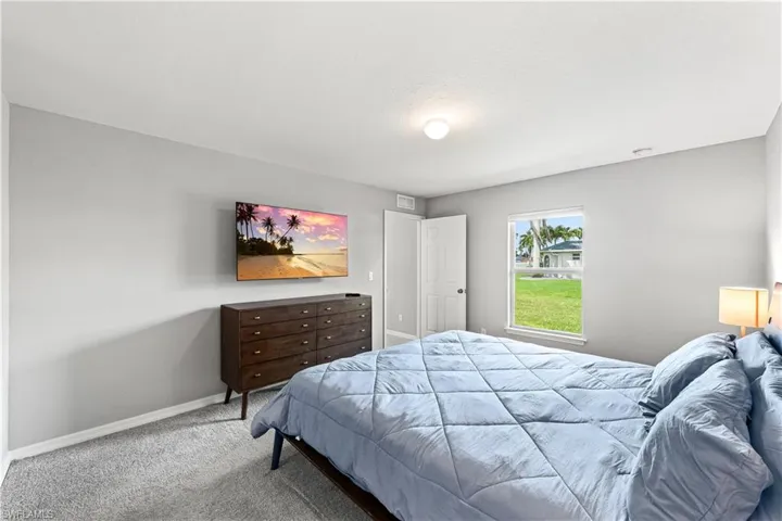 Carpeted bedroom featuring baseboards