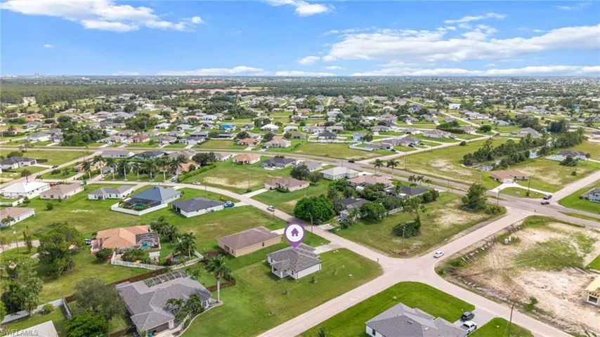 Aerial view of property's location featuring nearby suburban area