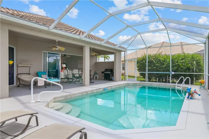Pool featuring a patio, a grill, a ceiling fan, and a lanai