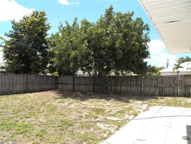 Large backyard with fence and gate