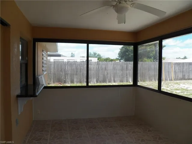 Large sunroom with screens and sliding windows