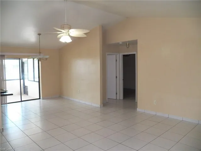 Living and dining area featuring lofted ceiling and a ceiling fan