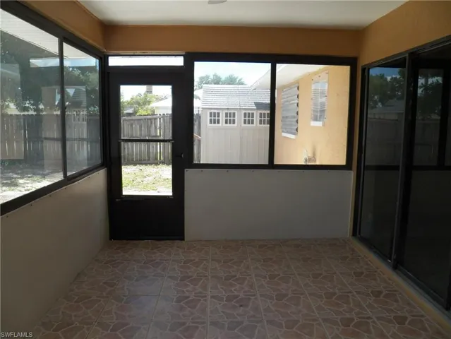 Sunroom with storm door to the yard