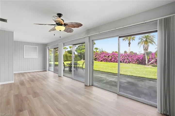 Empty room with light wood-type flooring and a ceiling fan
