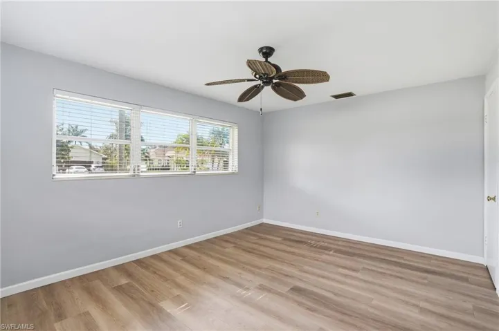 Unfurnished room featuring light wood-type flooring and ceiling fan
