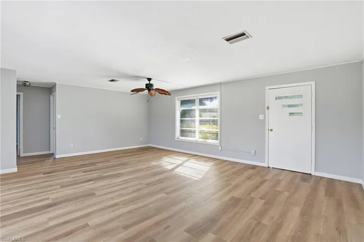 Unfurnished living room with light wood-type flooring and a ceiling fan