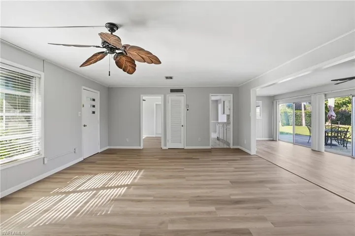 Unfurnished living room featuring ceiling fan and light wood finished floors