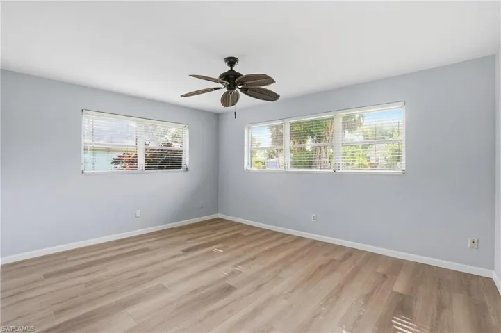 Unfurnished room featuring light wood-style flooring and a ceiling fan