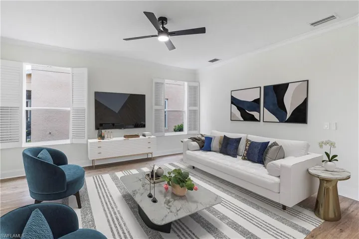 Living area featuring ornamental molding, wood finished floors, and ceiling fan