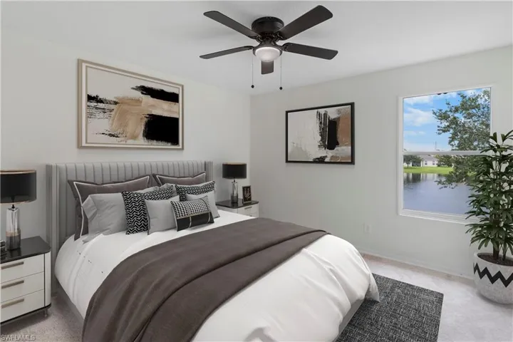 Bedroom featuring light carpet and a ceiling fan
