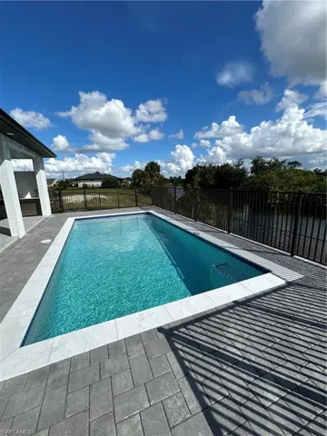 View of pool featuring a fenced backyard and a patio