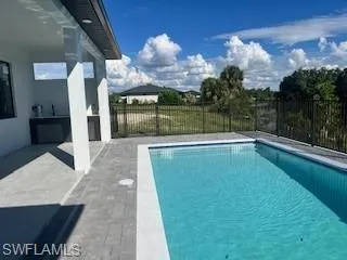 View of pool with a patio and a fenced backyard