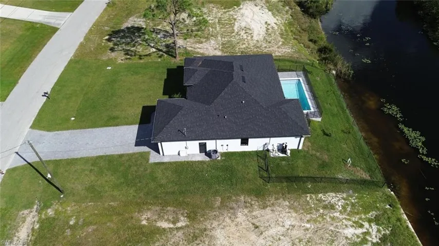 Aerial view of property's location with a nearby body of water