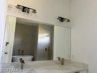 Bathroom featuring double vanity and a freestanding bath