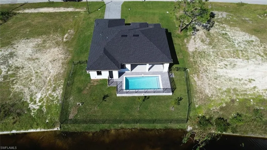 View of subject property featuring a pool area