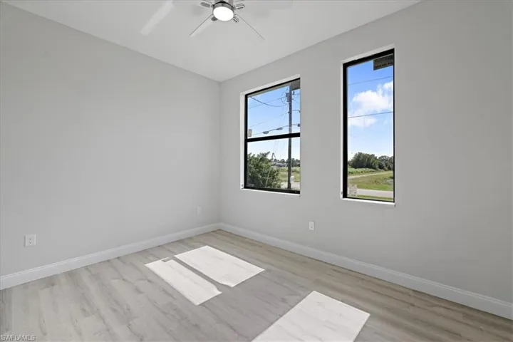 Unfurnished room with light wood-style floors and a ceiling fan