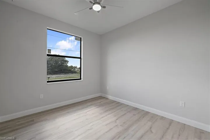 Unfurnished room with light wood finished floors and a ceiling fan