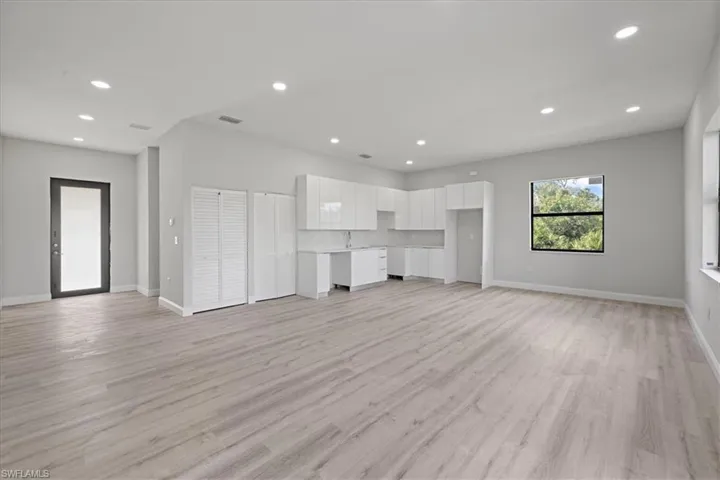 Unfurnished living room with light wood-style flooring and recessed lighting