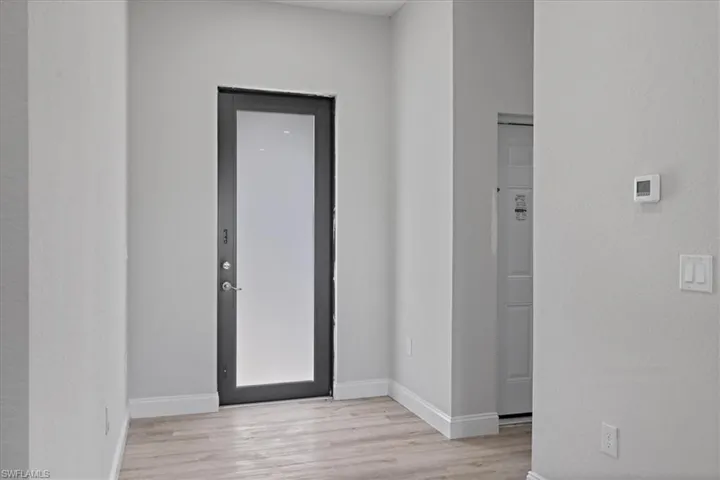 Foyer featuring light wood-type flooring and baseboards