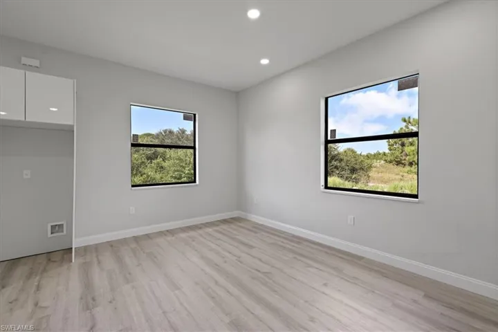 Spare room with recessed lighting, healthy amount of natural light, and light wood-type flooring