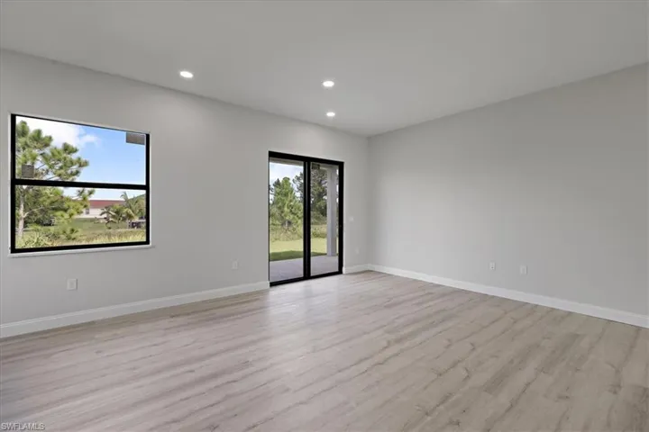 Spare room with light wood-style floors and recessed lighting