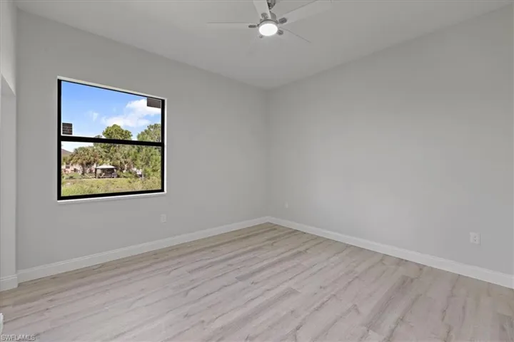 Spare room featuring light wood-style flooring and a ceiling fan