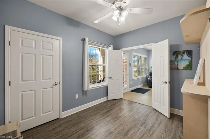 Unfurnished bedroom featuring wood finished floors and ceiling fan