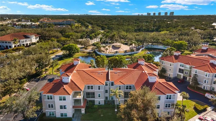Drone / aerial view of apartment complex and a large body of water