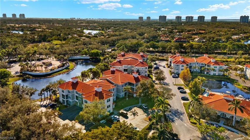 View of urban area with a nearby body of water and a tree filled landscape