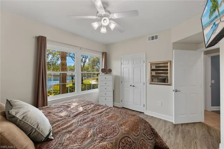 Bedroom featuring light wood-type flooring, ceiling fan, and a closet