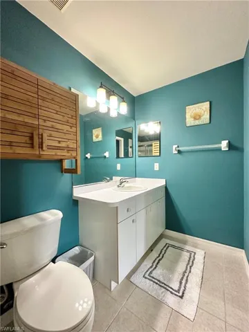 Bathroom with vanity, tile patterned flooring, and toilet