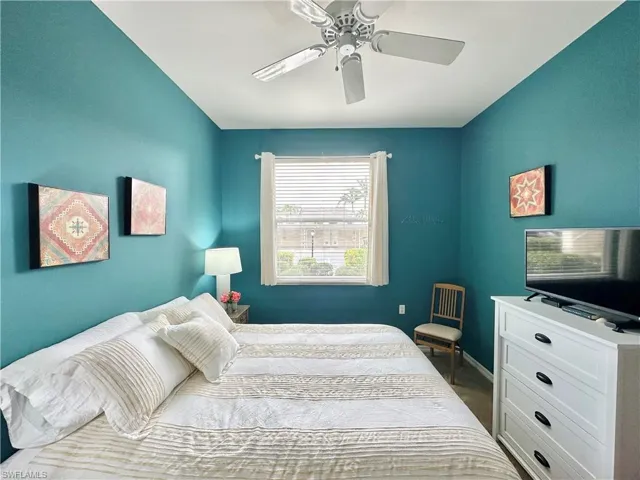 Bedroom with ceiling fan and carpet
