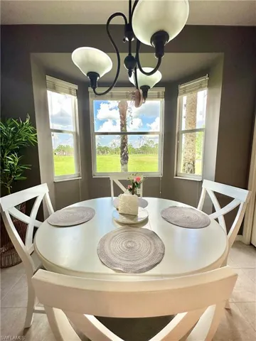 Dining room with an inviting chandelier and light tile patterned floors