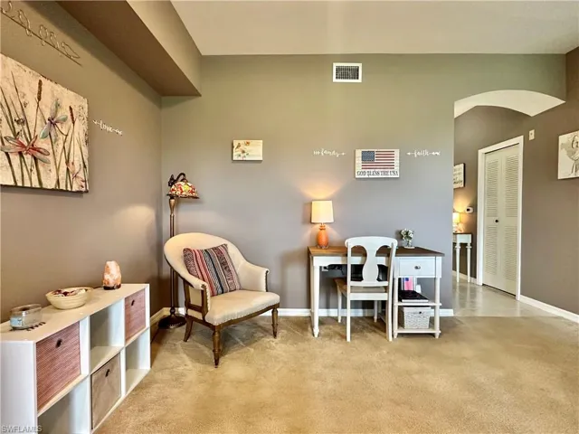 Sitting room featuring light colored carpet