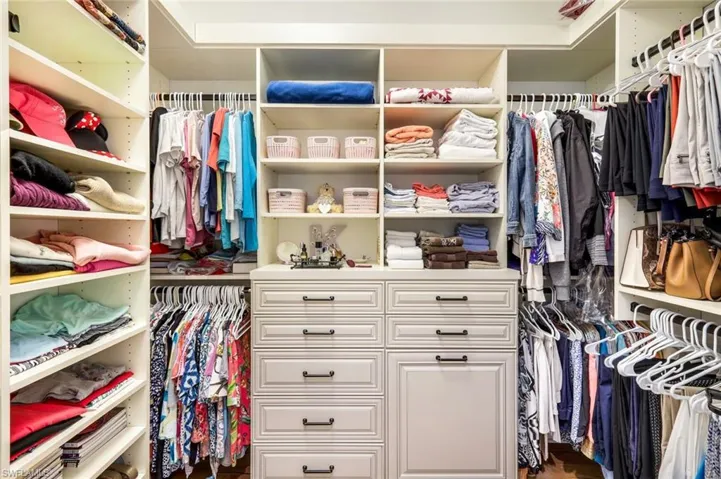 View of walk in custom closet in Primary Bedroom.  Each of the bedrooms have custom closets.