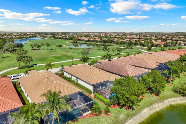 Birds eye view of property with a water view and golf course.