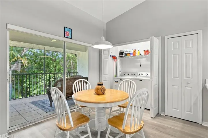 Spacious screened balcony with tile flooring, bifold closet doors for laundry and ironing board