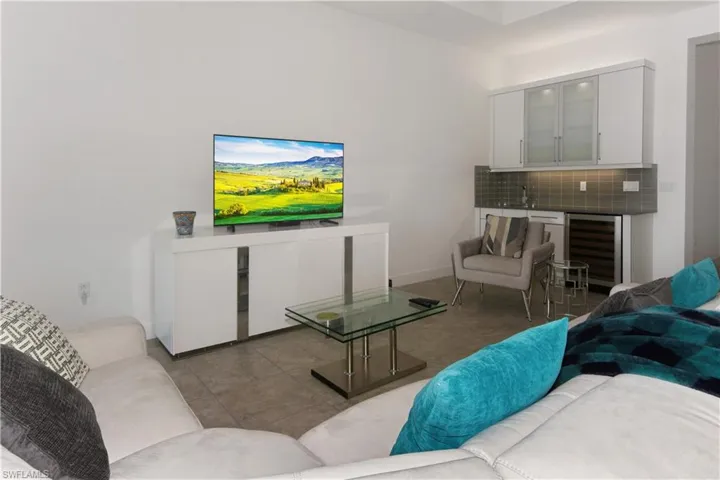 Tiled living room featuring beverage cooler and bar
