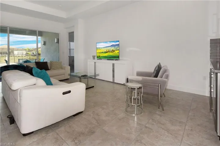 Living room featuring beverage cooler and a raised ceiling