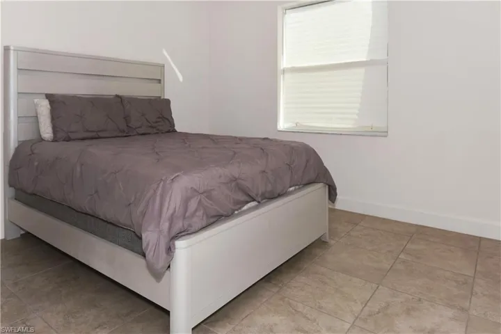 Bedroom with light tile patterned floors