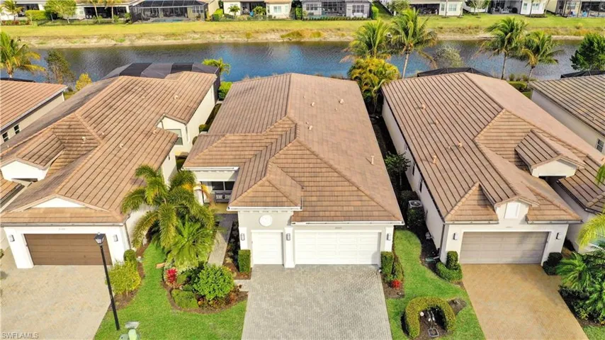 Aerial view of residential area featuring a nearby body of water