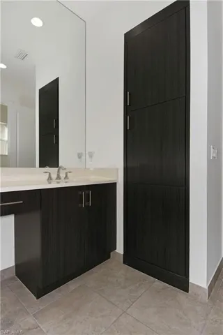 Bathroom with vanity and recessed lighting
